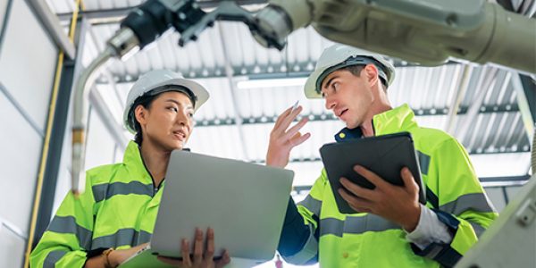 Skilled manufacturing employees working alongside automated production technology, illustrating how talent strategy has become central to every manufacturing challenge.